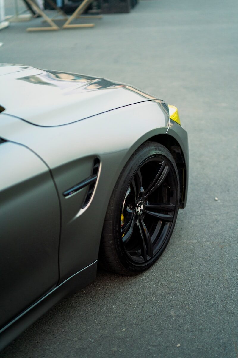Close-up of a sleek, dark gray car wheel.